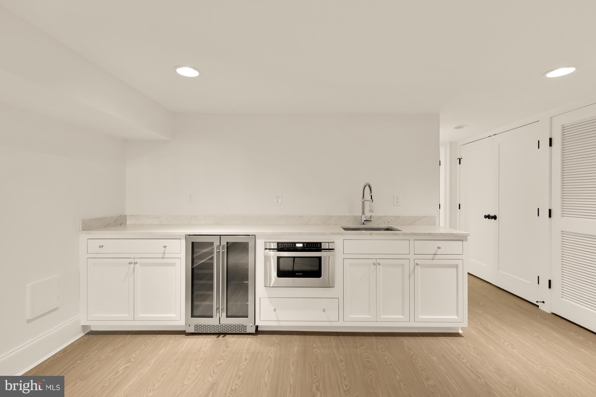 1412 Perry Place Northwest Washington, DC 20010 - Photo 40 of 52 a kitchen with stainless steel appliances a stove a microwave and white cabinets