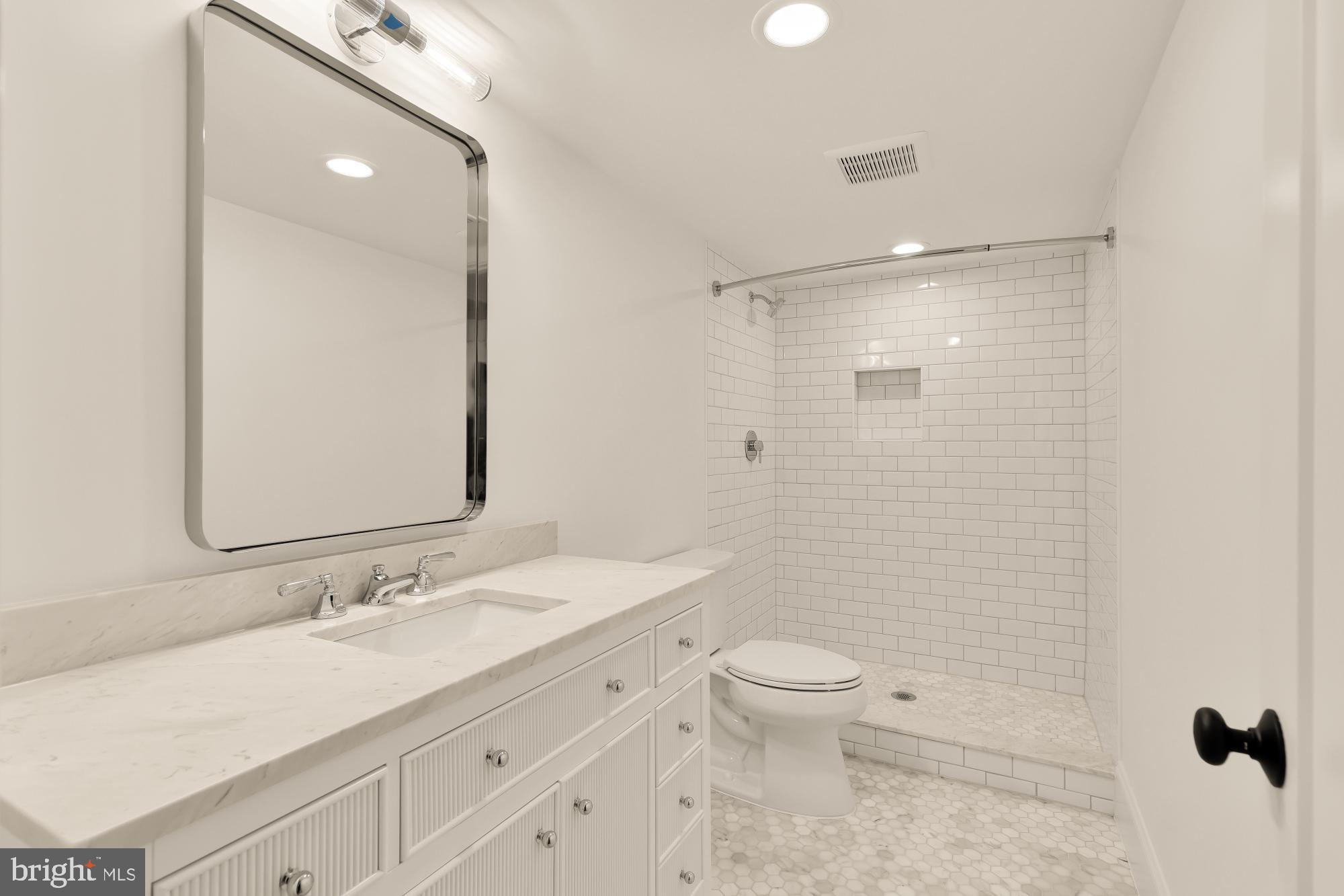 1412 Perry Place Northwest Washington, DC 20010 - Photo 42 of 52 a bathroom with a granite countertop sink a toilet and shower