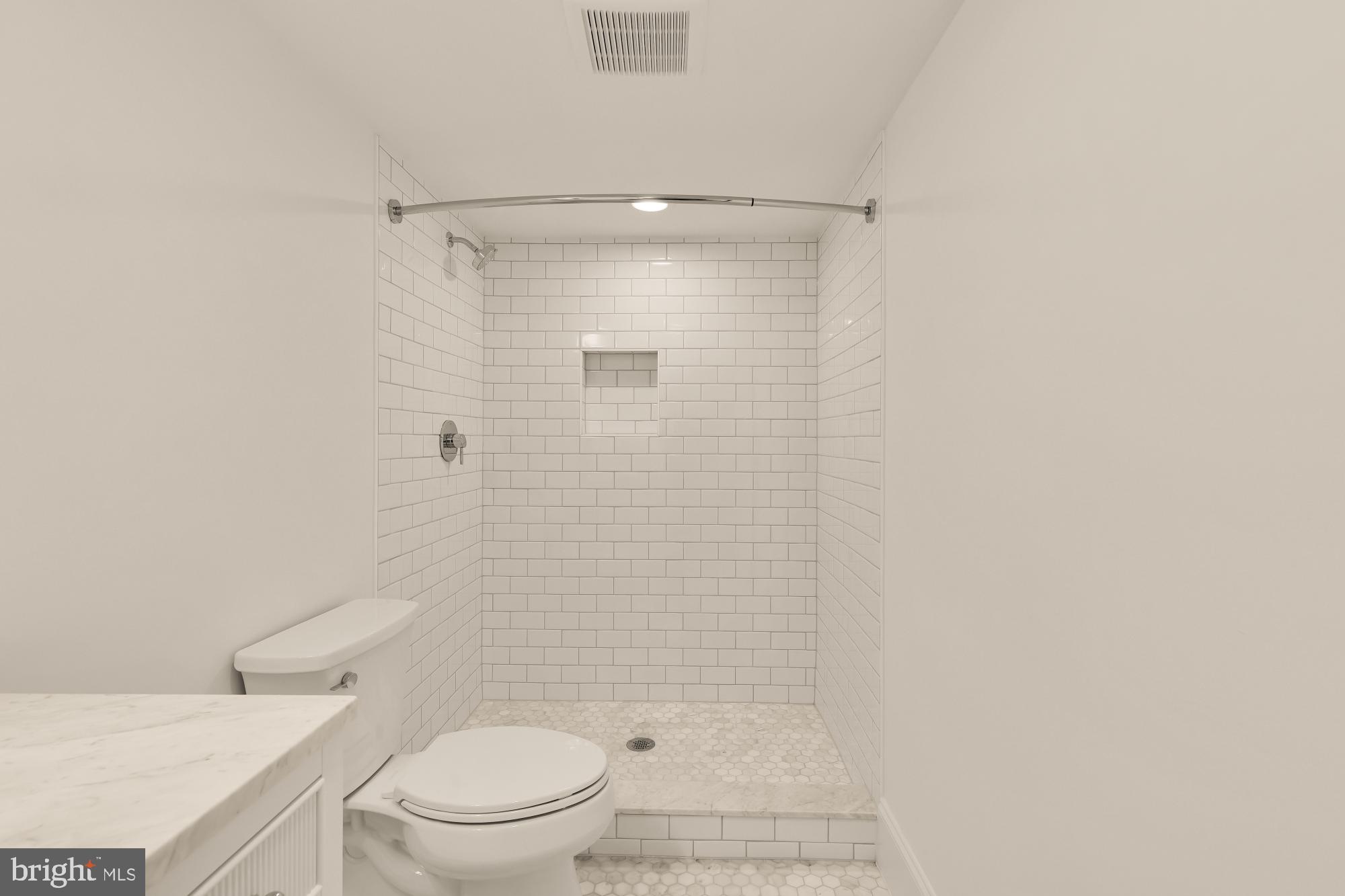 1412 Perry Place Northwest Washington, DC 20010 - Photo 43 of 52 a bathroom with a toilet and a shower