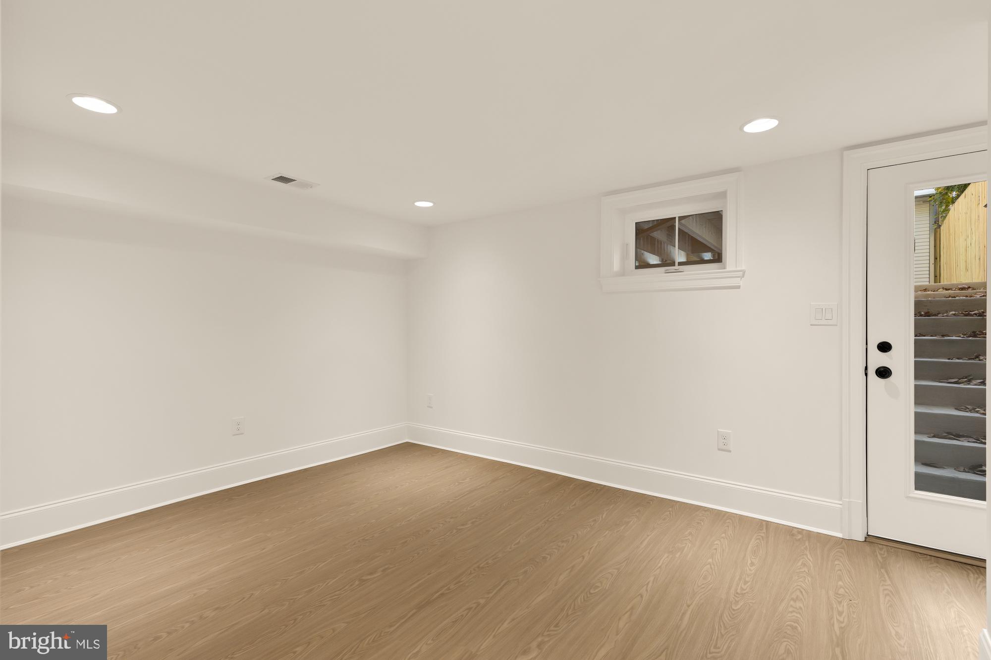 1412 Perry Place Northwest Washington, DC 20010 - Photo 44 of 52 an empty room with wooden floor and windows