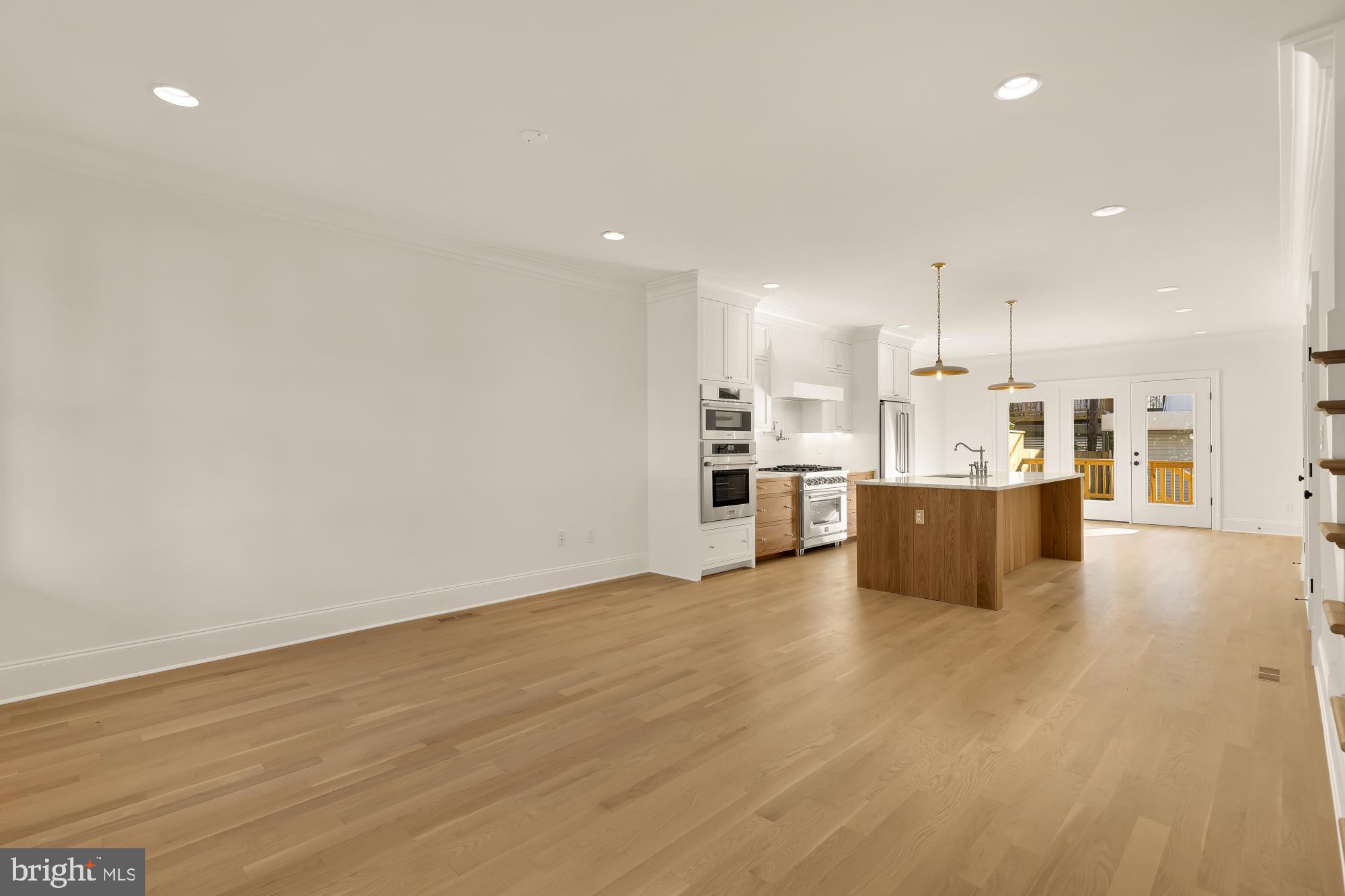 1412 Perry Place Northwest Washington, DC 20010 - Photo 7 of 52 a view of kitchen with kitchen island a sink wooden floor and white appliances