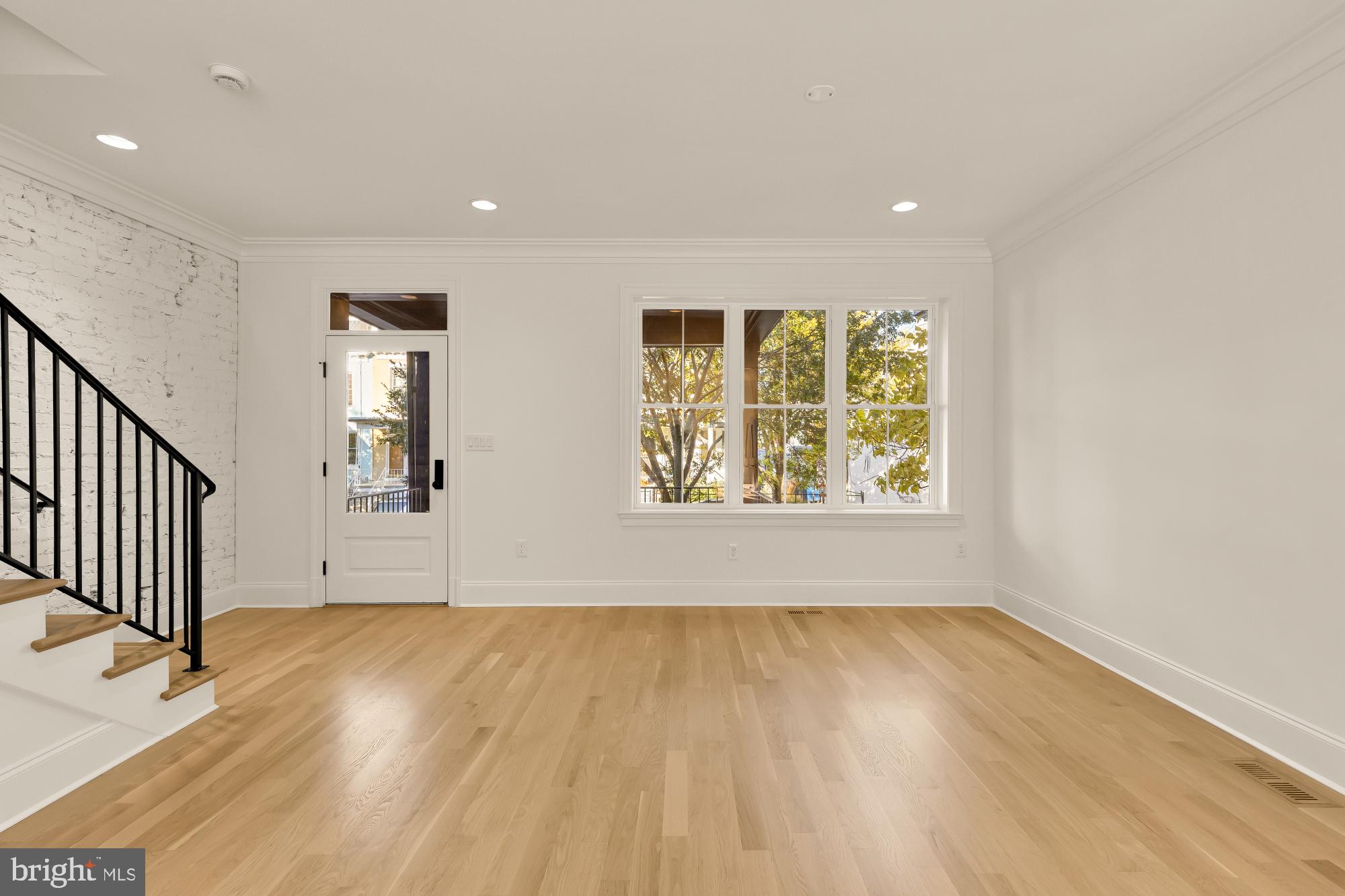 1412 Perry Place Northwest Washington, DC 20010 - Photo 10 of 52 wooden floor in an empty room with a window