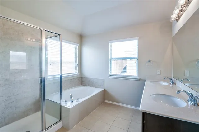 a bathroom with a tub sink and mirror