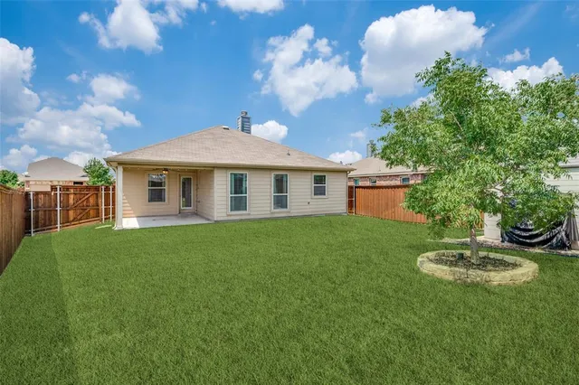 a front view of a house with a yard fire pit and outdoor seating