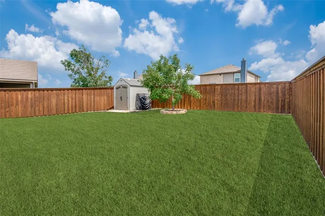 a view of backyard with trampoline