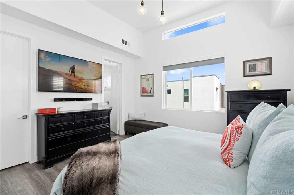 1267 Westreef Costa Mesa, CA 92627 - Photo 11 of 34 a bedroom with a bed and a flat screen tv