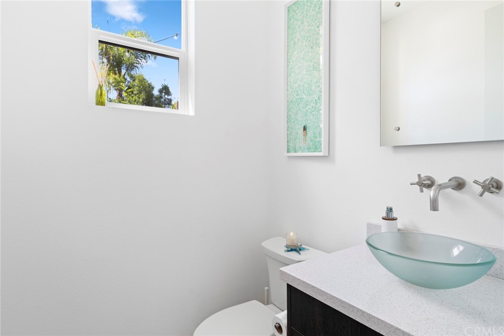 1267 Westreef Costa Mesa, CA 92627 - Photo 14 of 34 a bathroom with a toilet and a sink