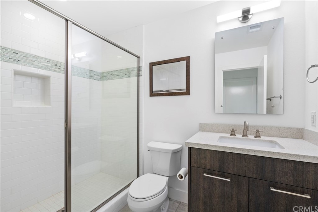 1267 Westreef Costa Mesa, CA 92627 - Photo 15 of 34 a bathroom with a sink a toilet a mirror and shower