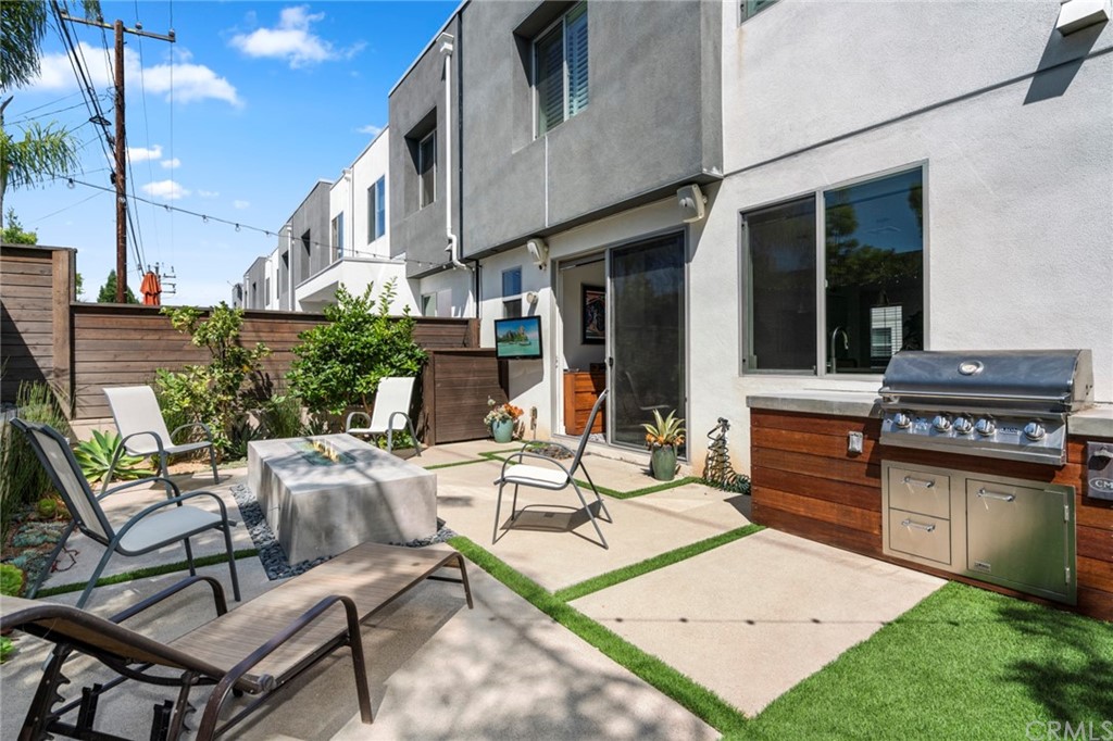 1267 Westreef Costa Mesa, CA 92627 - Photo 19 of 34 a view of a patio with table and chairs and potted plants