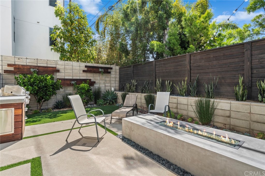 1267 Westreef Costa Mesa, CA 92627 - Photo 20 of 34 a view of backyard with outdoor seating and wooden fence