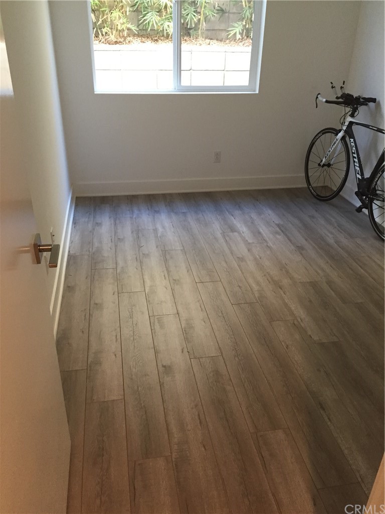 1267 Westreef Costa Mesa, CA 92627 - Photo 26 of 34 a view of a room with wooden floor and windows