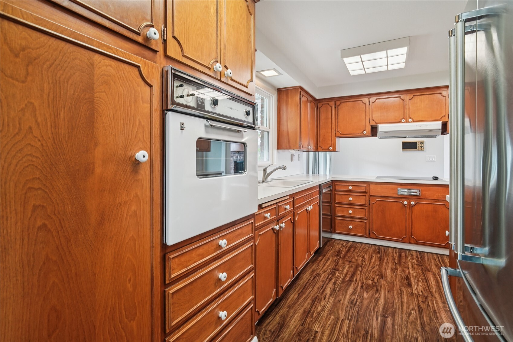 715 35th Street Everett, WA 98201 - Photo 13 of 36 a kitchen with stainless steel appliances granite countertop a refrigerator a sink and wooden floors