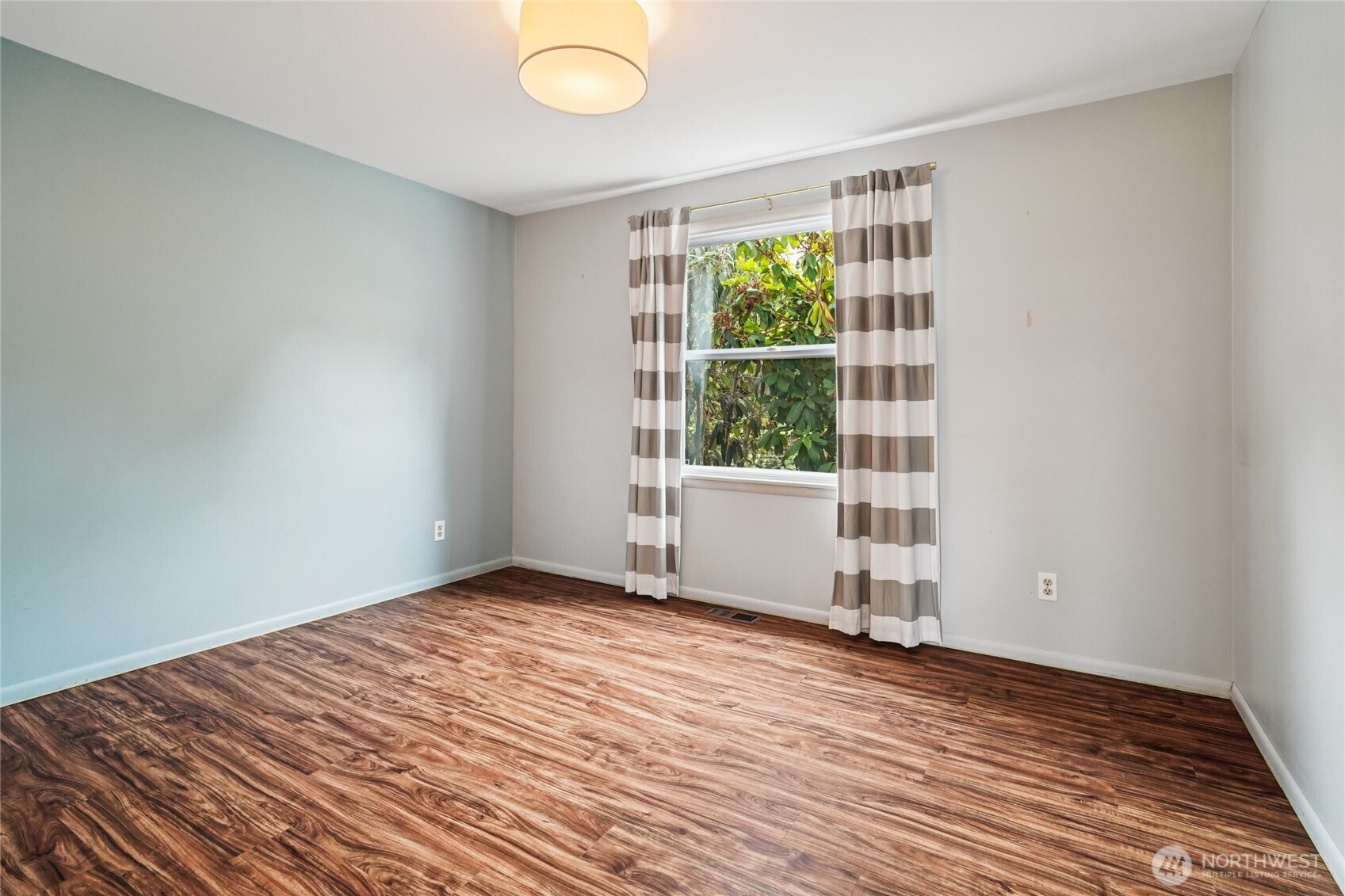 715 35th Street Everett, WA 98201 - Photo 21 of 36 an empty room with wooden floor and windows