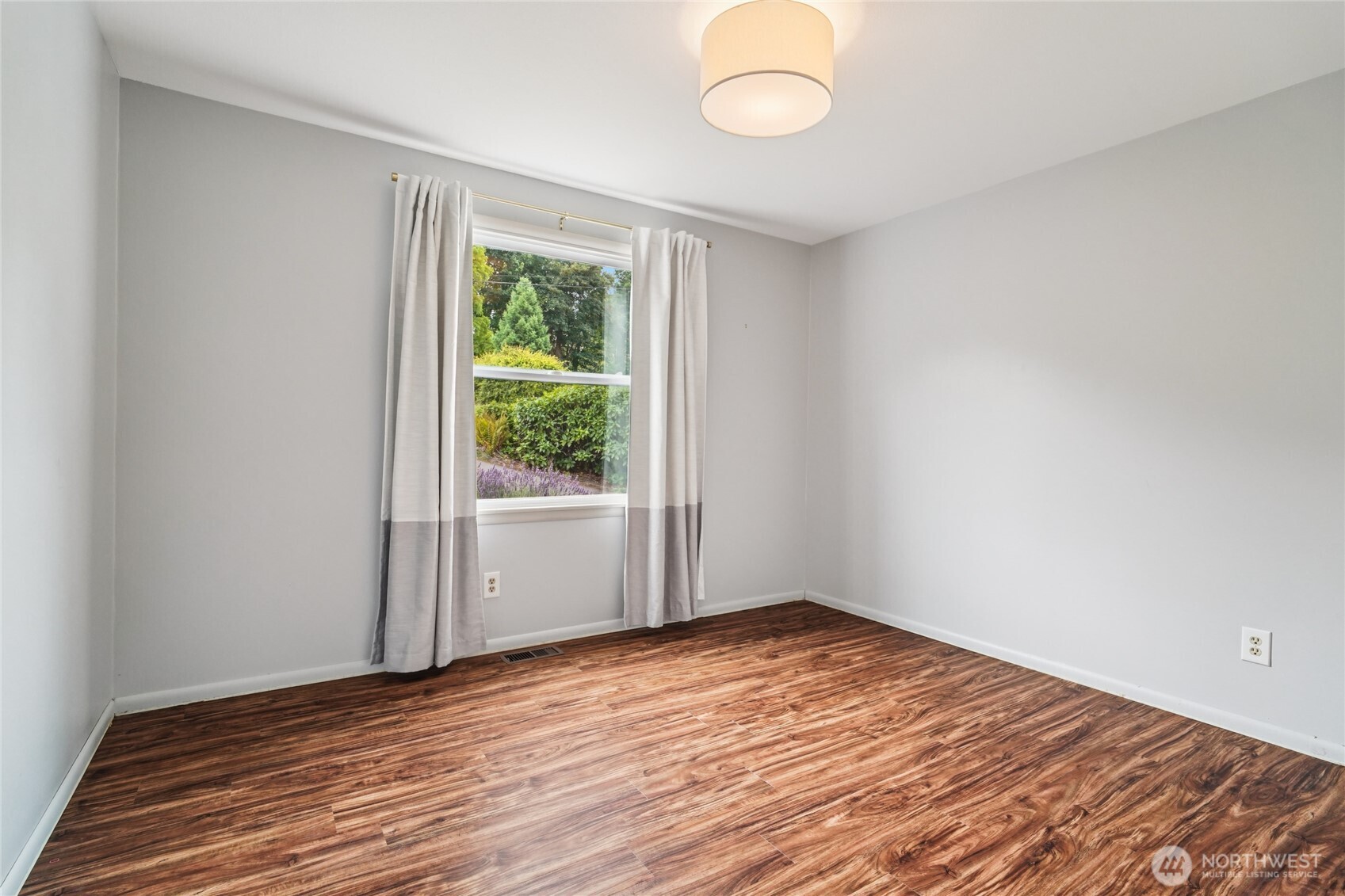 715 35th Street Everett, WA 98201 - Photo 23 of 36 a view of empty room with wooden floor and fan