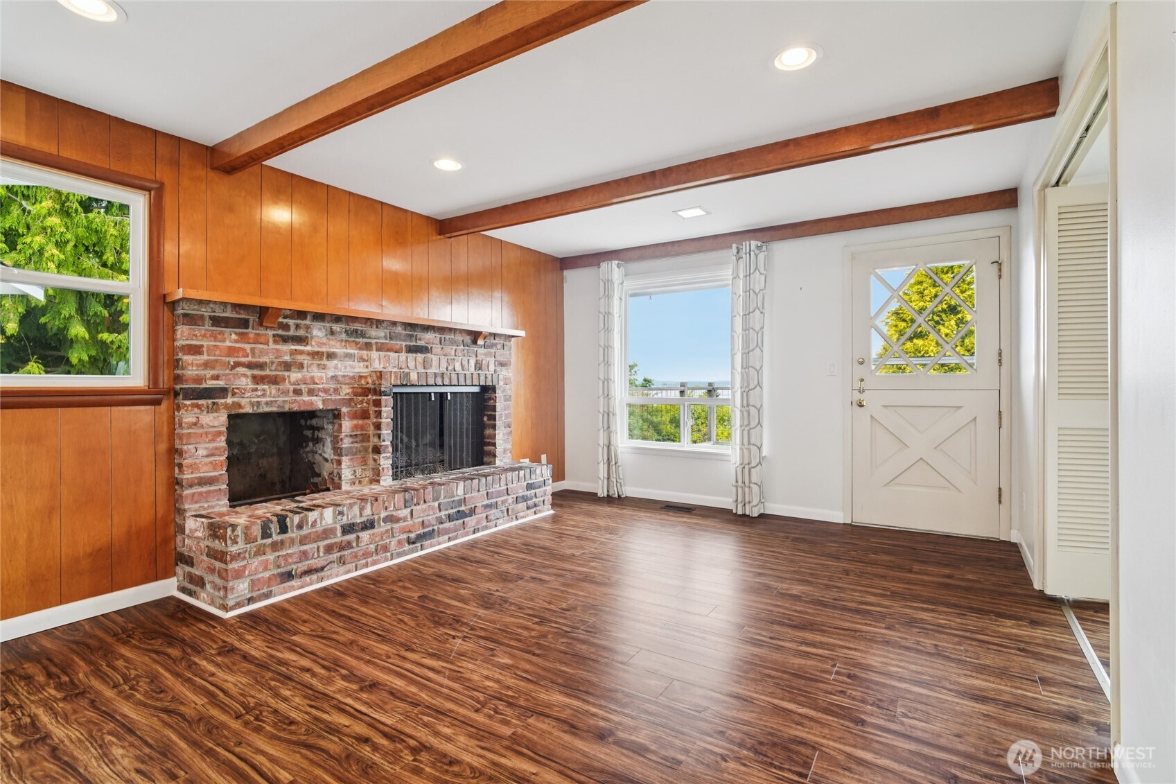 715 35th Street Everett, WA 98201 - Photo 8 of 36 a view of an empty room with a fireplace and a window