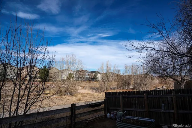 a view of a backyard with wooden fence