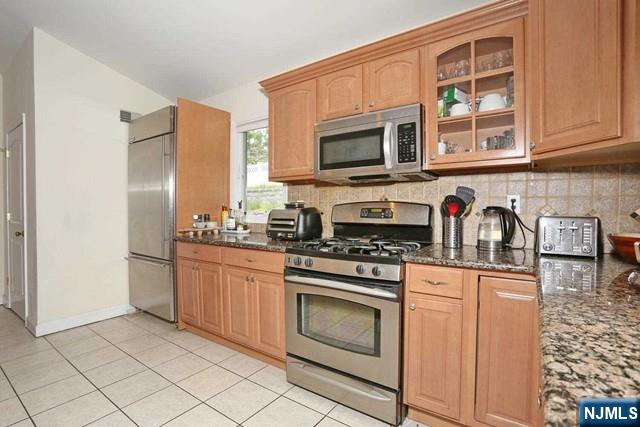 84 12th Street Cresskill, NJ 07626 - Photo 20 of 45 a kitchen with stainless steel appliances granite countertop a stove a sink and a microwave