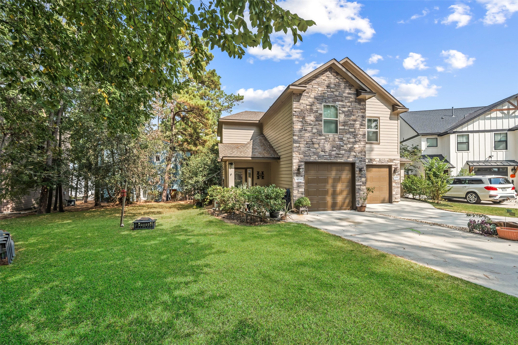 a front view of a house with a garden and yard