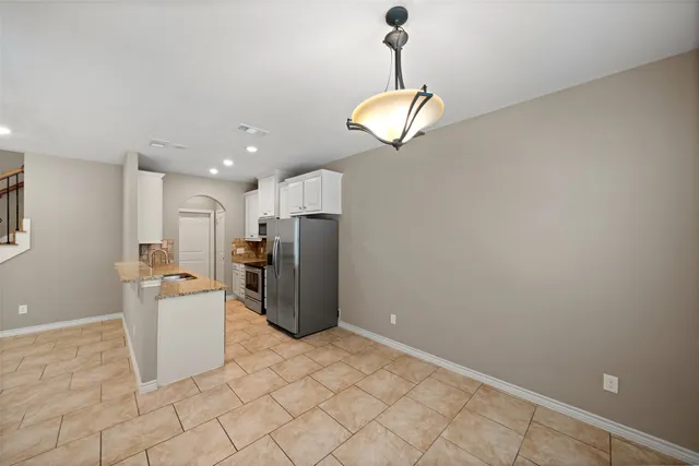 a kitchen with stainless steel appliances a refrigerator sink and microwave