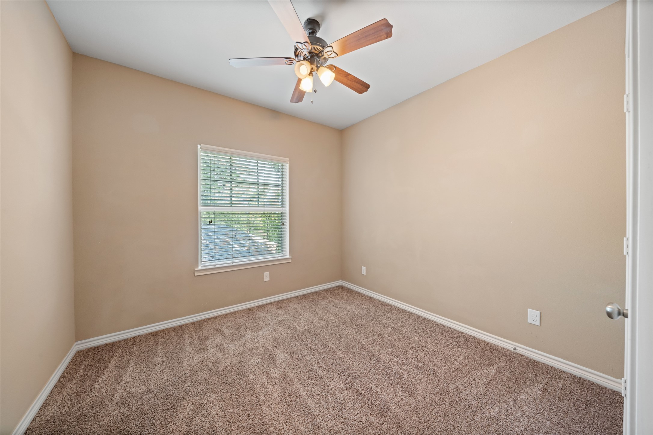 1413 East April Villa, Unit B Conroe, TX 77356 - Photo 20 of 33 an empty room with windows and fan