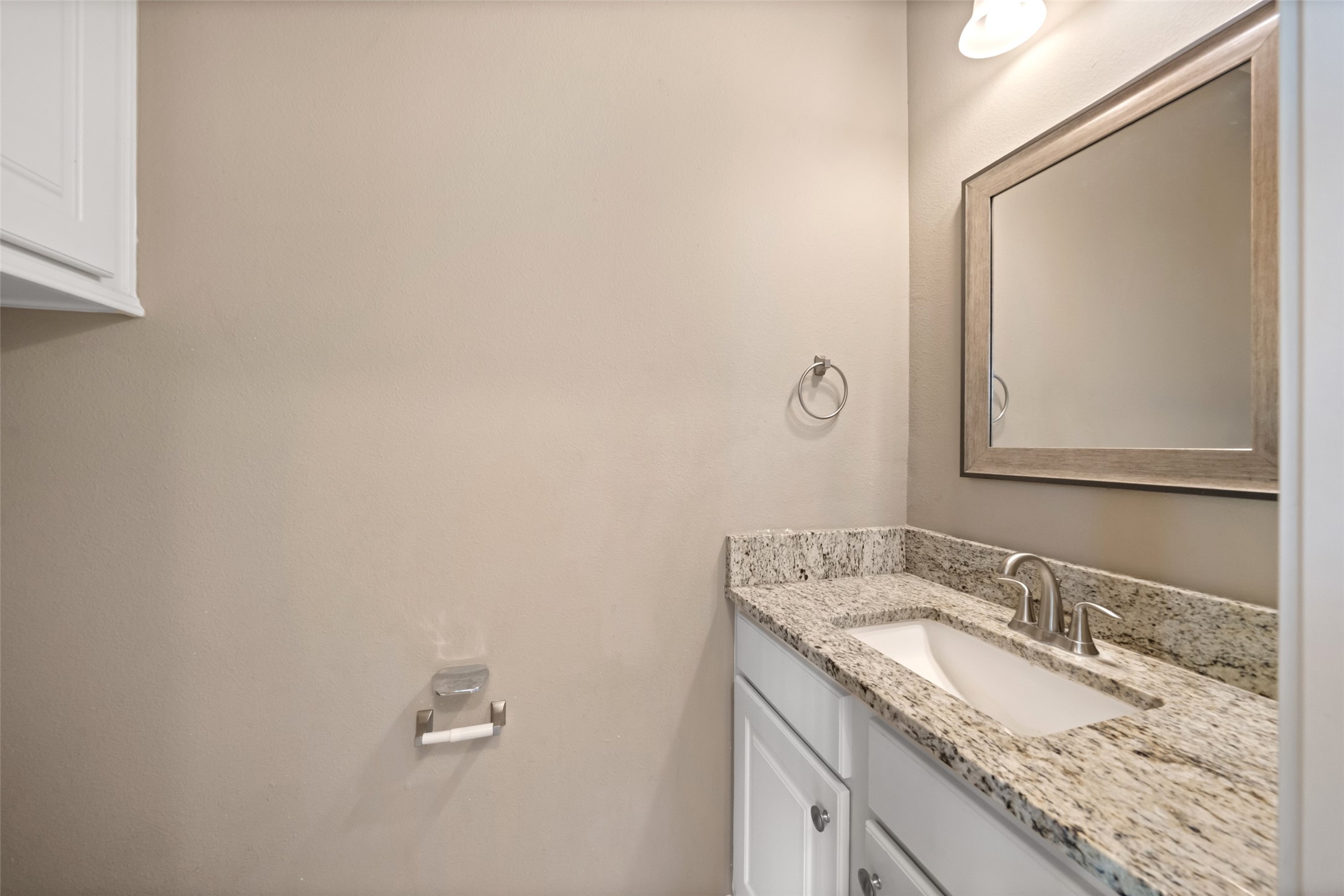 1413 East April Villa, Unit B Conroe, TX 77356 - Photo 22 of 33 a bathroom with a granite countertop sink and a mirror