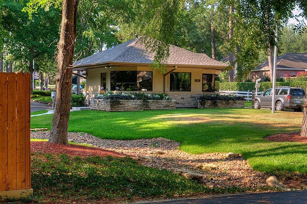 1413 East April Villa, Unit B Conroe, TX 77356 - Photo 26 of 33 a front view of a house with garden and sitting area