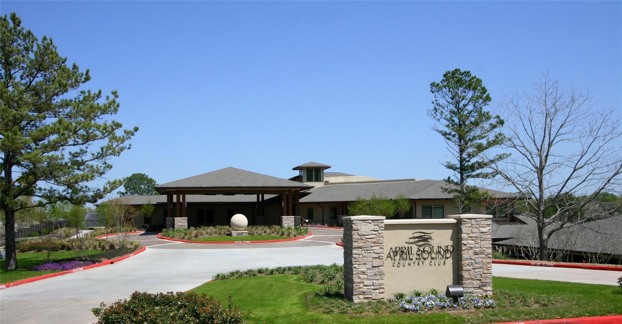 1413 East April Villa, Unit B Conroe, TX 77356 - Photo 28 of 33 a front view of a house with a yard and garage