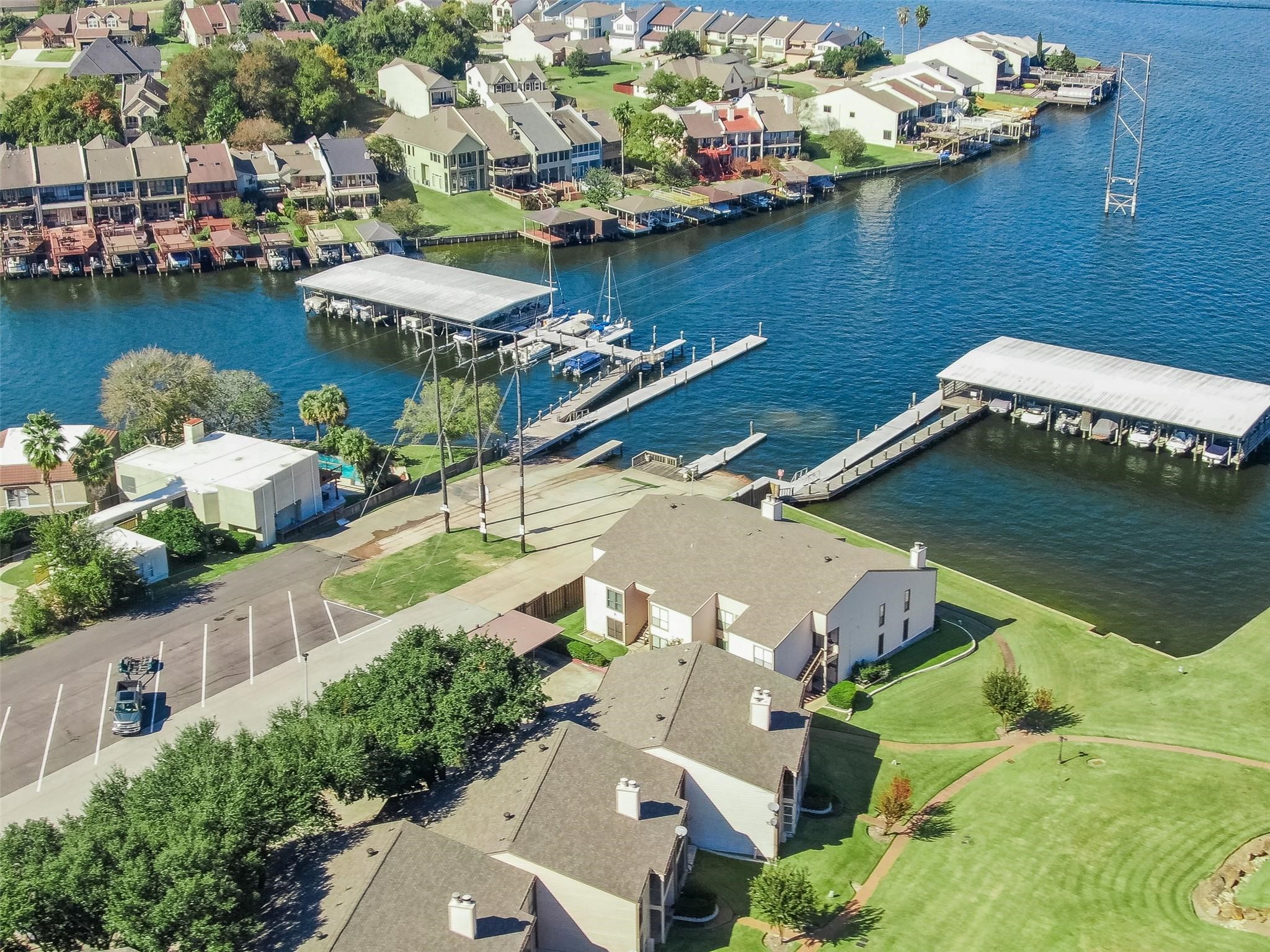 1413 East April Villa, Unit B Conroe, TX 77356 - Photo 31 of 33 an aerial view of a house with a lake view