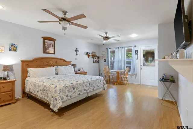 a bedroom with a bed a couch and dresser