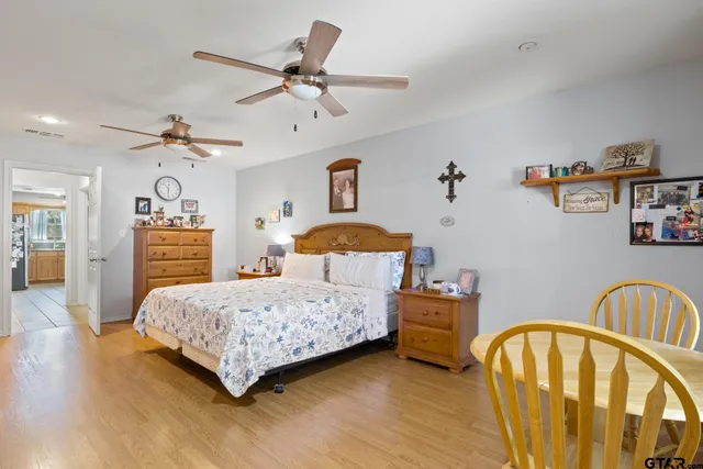 a bedroom with a bed and a chandelier