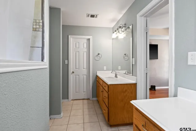 a view of a bathroom with a sink and mirror