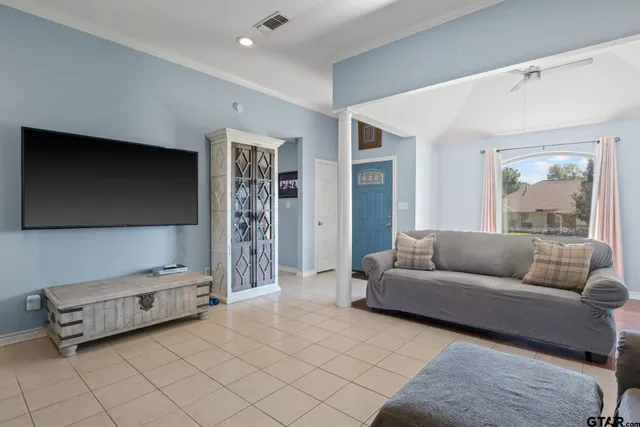 a living room with furniture and a flat screen tv