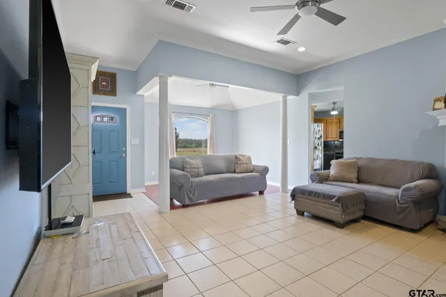 a living room with a couch and a ceiling fan