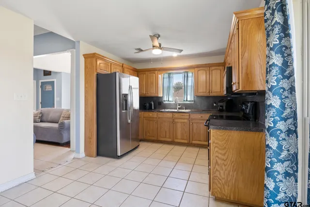 a kitchen with a refrigerator a stove top oven a sink and dishwasher