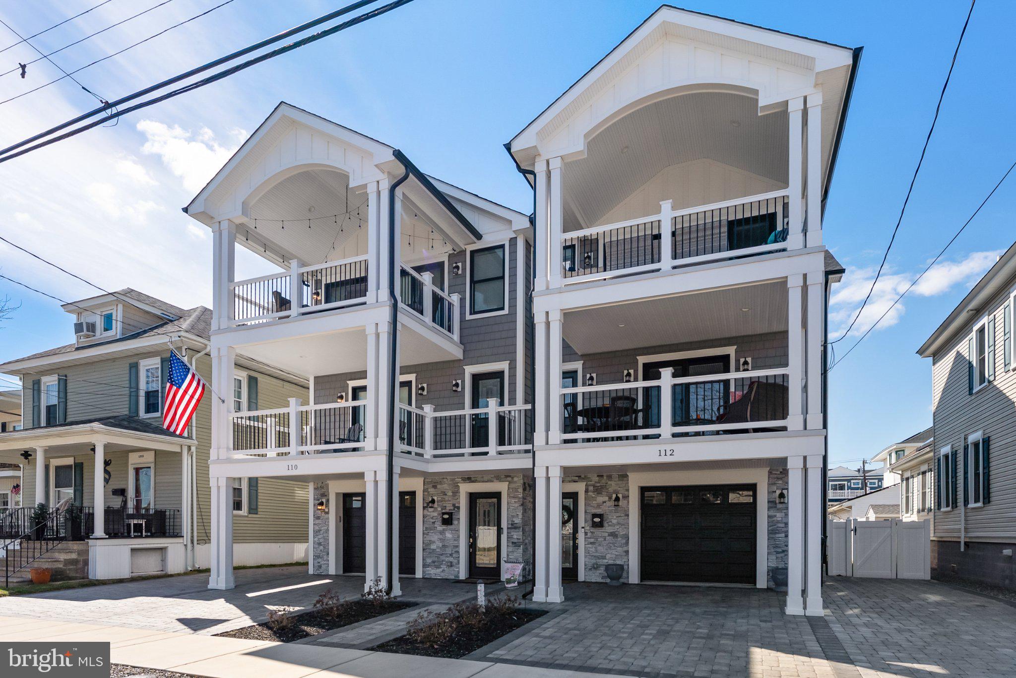 Charming coastal duplex with balconies.