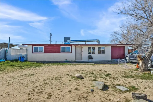 a house that has a tree in front of it