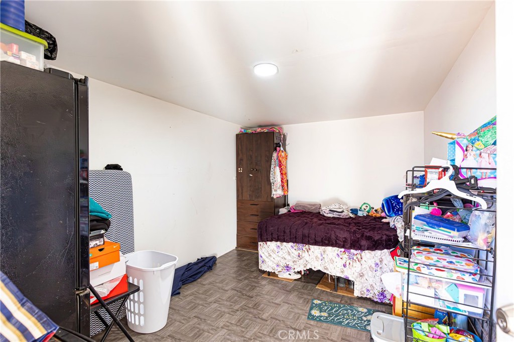 13325 Margo Street North Edwards, CA 93523 - Photo 11 of 17 a bedroom with a bed and a chandelier