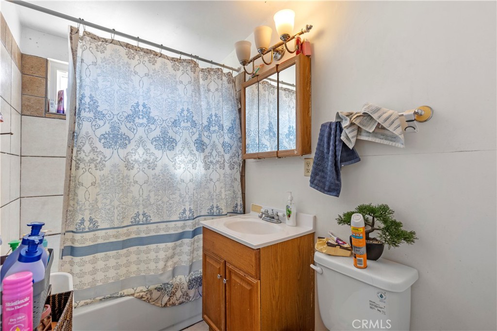 13325 Margo Street North Edwards, CA 93523 - Photo 13 of 17 a bathroom with a sink mirror vanity and toilet