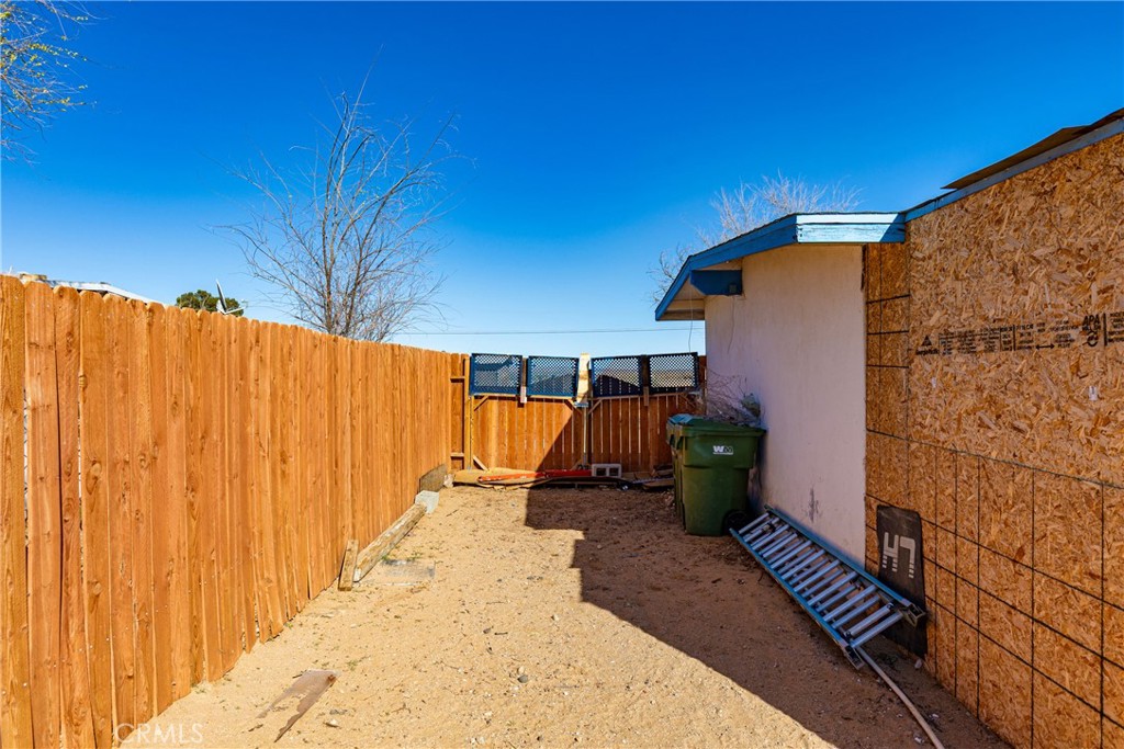 13325 Margo Street North Edwards, CA 93523 - Photo 14 of 17 a view of a backyard with wooden fence and a potted plant