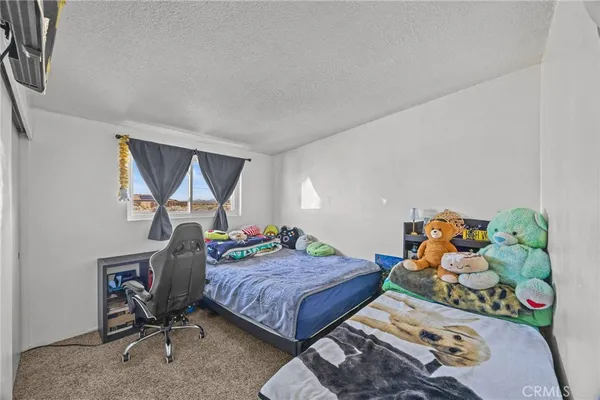 a bedroom with a bed and dresser