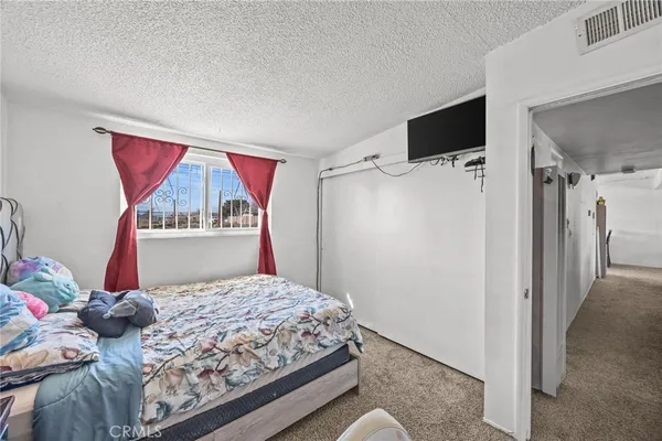 a bedroom with bed and wooden floor