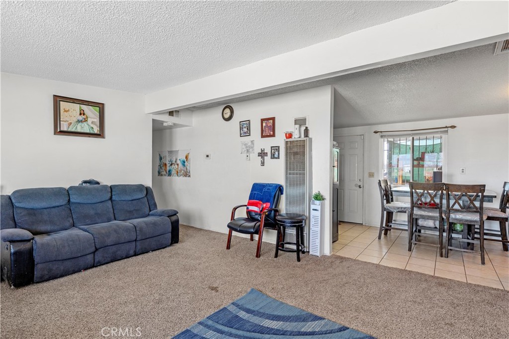 13325 Margo Street North Edwards, CA 93523 - Photo 3 of 17 a living room with furniture and a dining table with wooden floor
