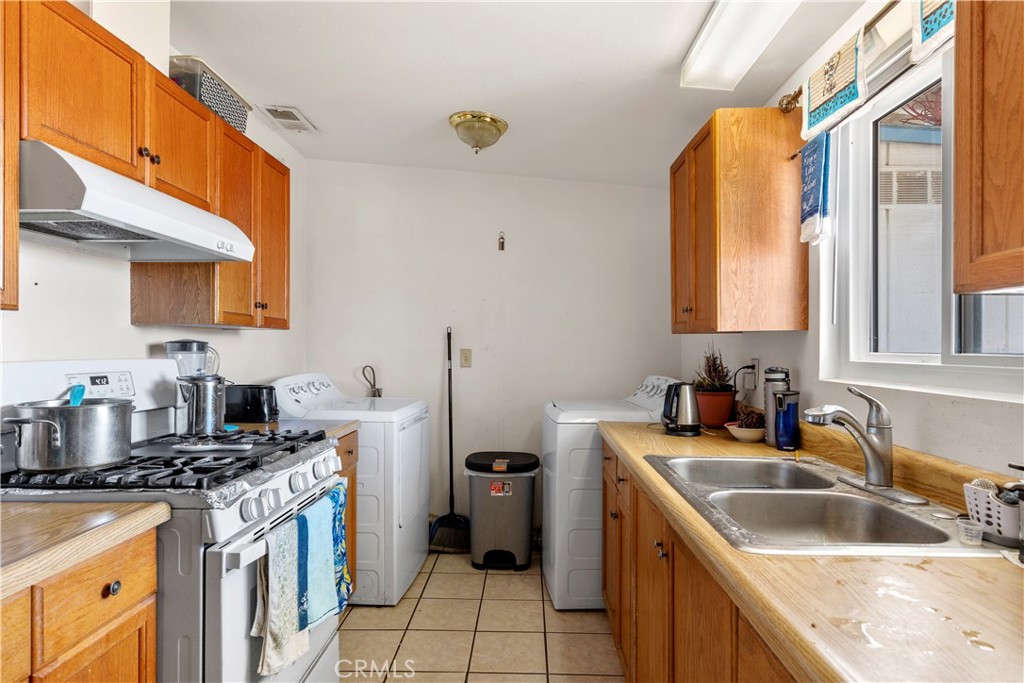 13325 Margo Street North Edwards, CA 93523 - Photo 6 of 17 a kitchen with a sink stove top oven and refrigerator