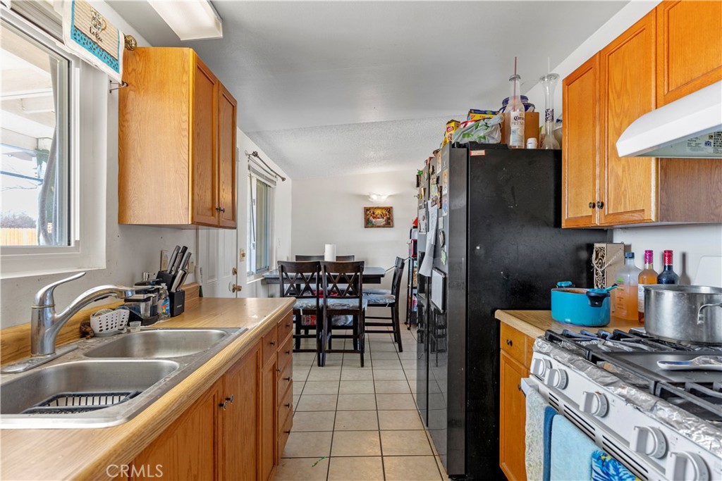13325 Margo Street North Edwards, CA 93523 - Photo 7 of 17 a kitchen with stainless steel appliances granite countertop a sink stove and refrigerator