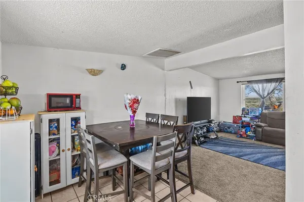 a view of a dining room with furniture and a potted plant