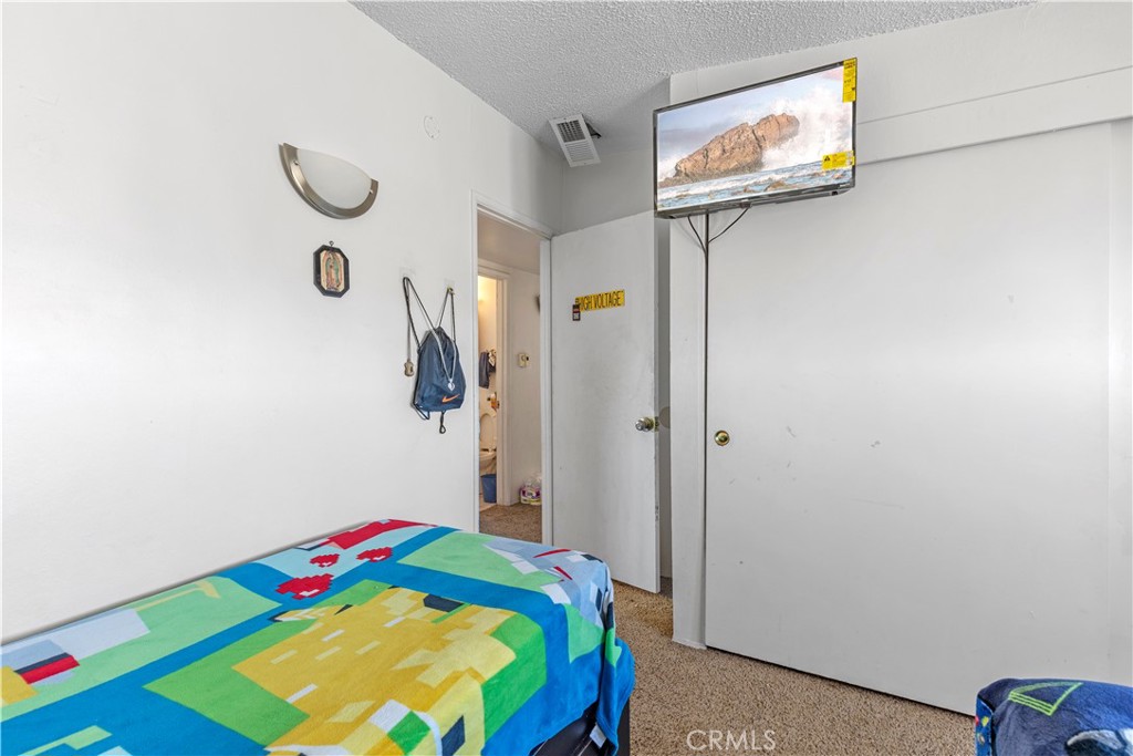 13325 Margo Street North Edwards, CA 93523 - Photo 9 of 17 a bedroom with a bed and a window