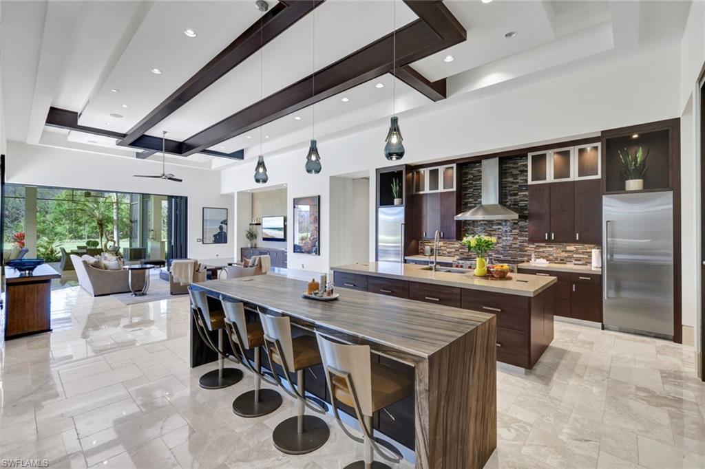 4431 Wayside Drive Naples, FL 34119 - Photo 15 of 49 a kitchen with stainless steel appliances granite countertop a stove refrigerator and cabinets