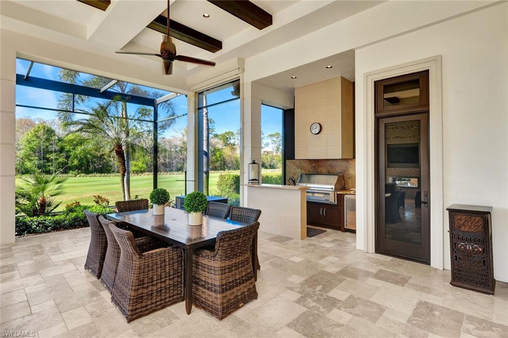 4431 Wayside Drive Naples, FL 34119 - Photo 23 of 49 a living room with furniture and a floor to ceiling window