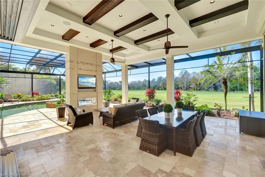 4431 Wayside Drive Naples, FL 34119 - Photo 25 of 49 a living room with patio furniture and garden view