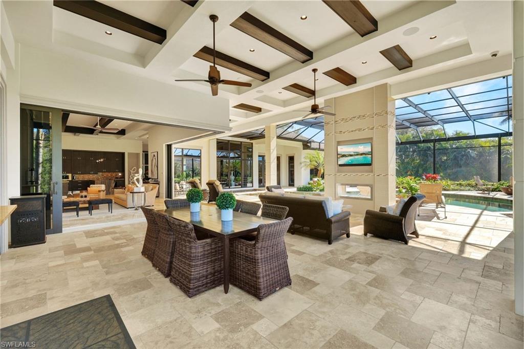 4431 Wayside Drive Naples, FL 34119 - Photo 26 of 49 a living room with patio furniture and a chandelier